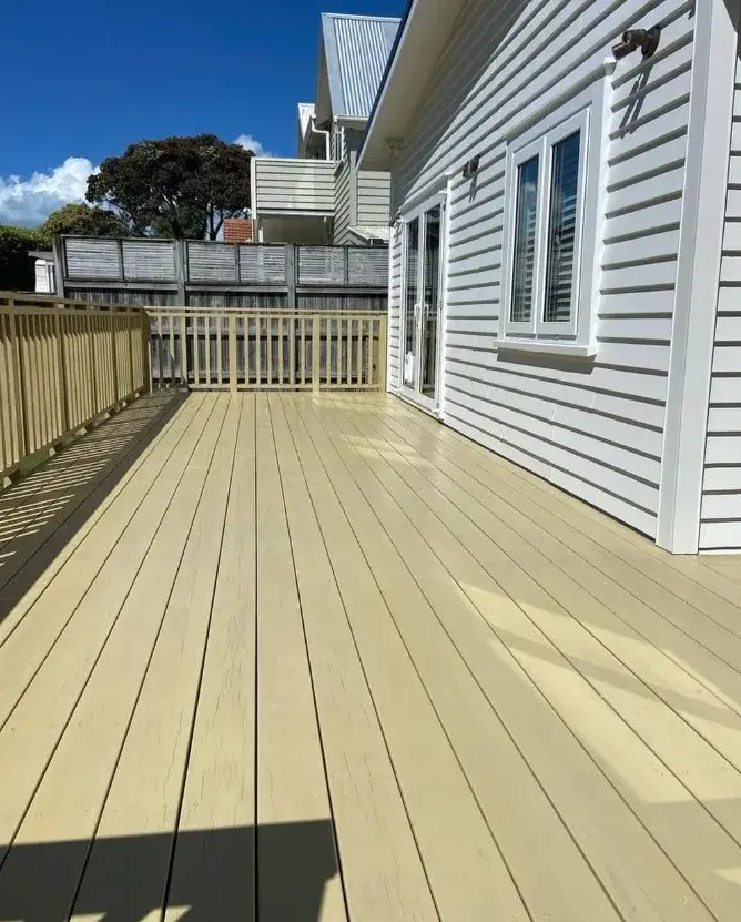 Cream painted timber deck attached to a white weatherboard home in Auckland