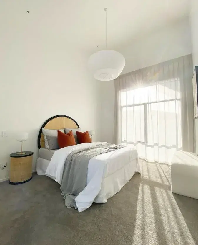 Modern bedroom with crisp white painted walls and pendant lighting