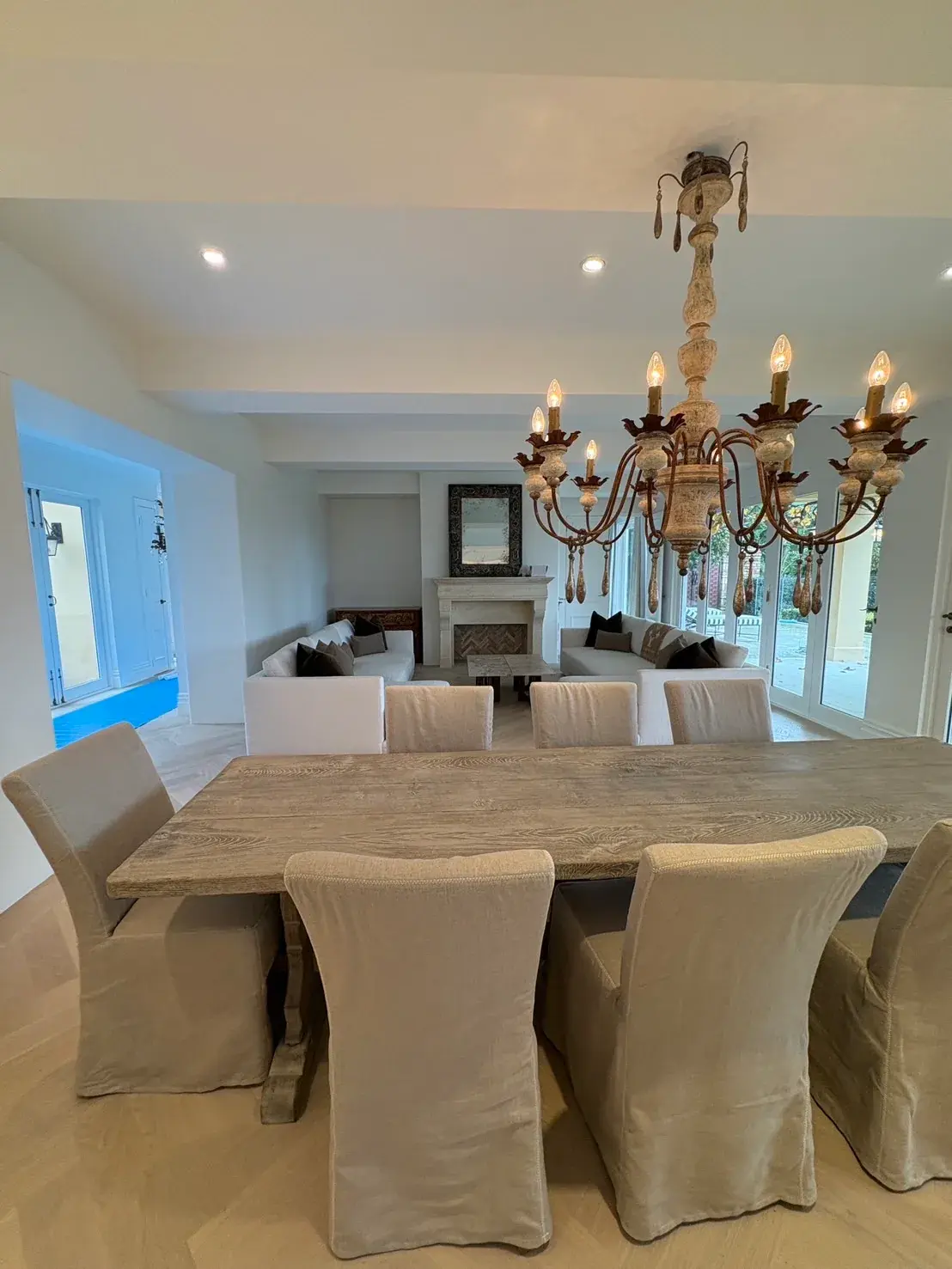 Freshly painted open-plan dining room with chandelier and crisp white ceiling